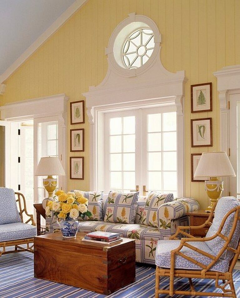 A casual living room with paneled yellow accent walls. The walls are soft yellow pale yellow in colors. The furnishings bring in shades of blue for a yellow and blue living room vignette.